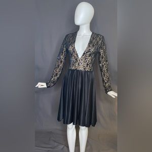 Black cocktail dress. Deep ‘V’ front, nude lining and swing skirt